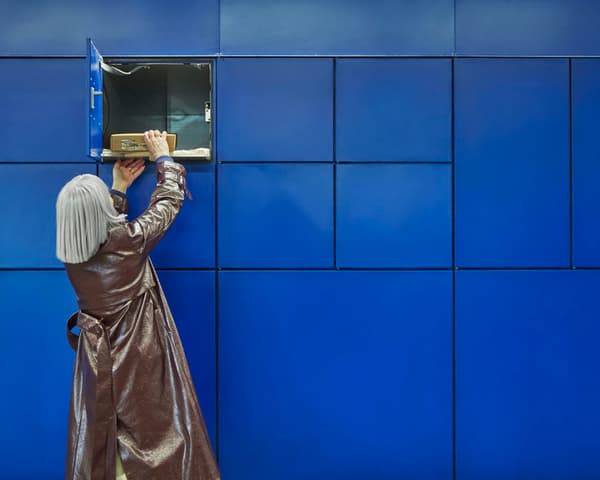 A customer collecting their order from a locker