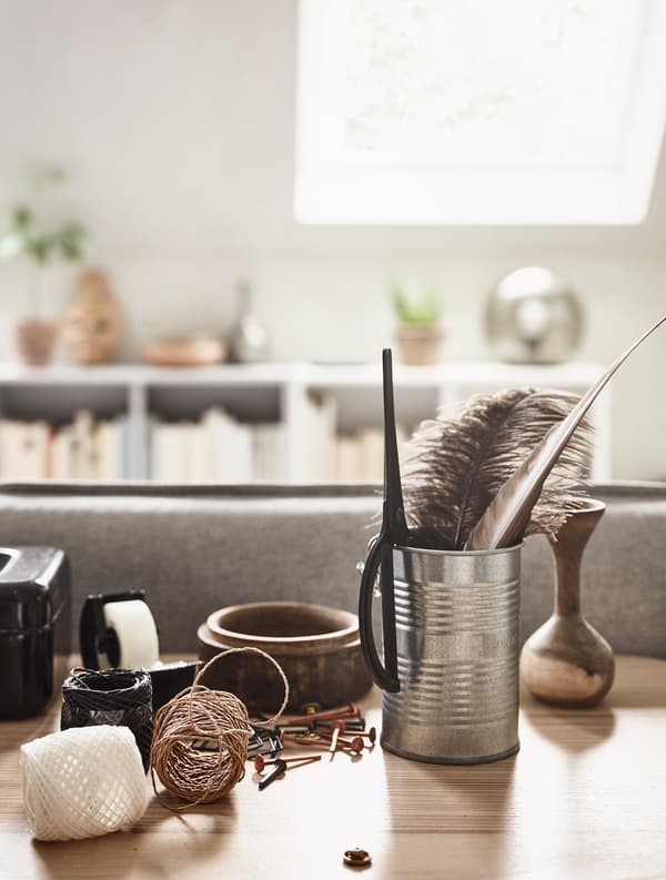 A desktops holds minimalist items like twine, and work essentials like tape.