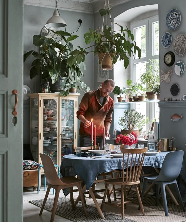 A dining room with cutlery, glassware, chairs and cushions.