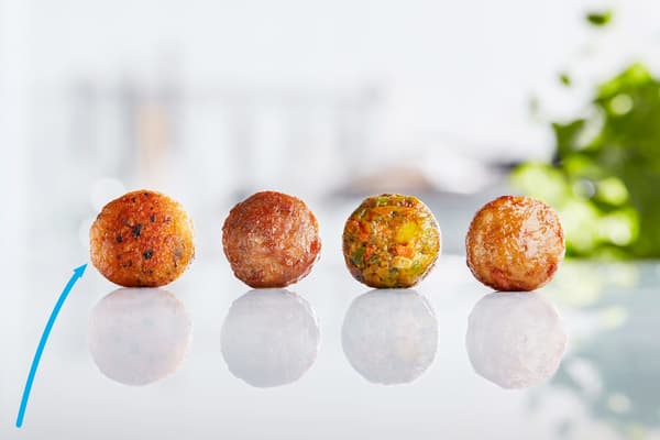 A display of four different IKEA meatballs including beef, chicken, veggie and the new salmon balls to provide more options.