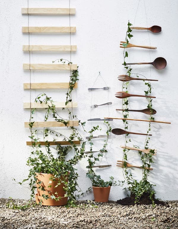 A DIY wall decoration made from bed slats and kitchen utensils.