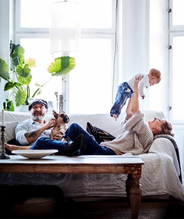 A family relaxing on the sofa together.