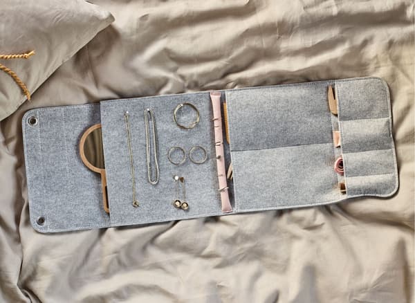 A felt hanging organiser turned into a diy jewellery travel case with spots for rings, necklaces, earrings, etc.  