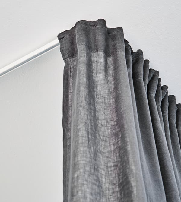 A floor-to-ceiling curtain help keeps your home workout gear separate from the rest of your space.