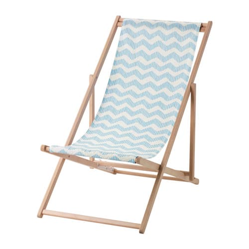 A foldable beach chair in wood with a blue and white patterned fabric seat.
