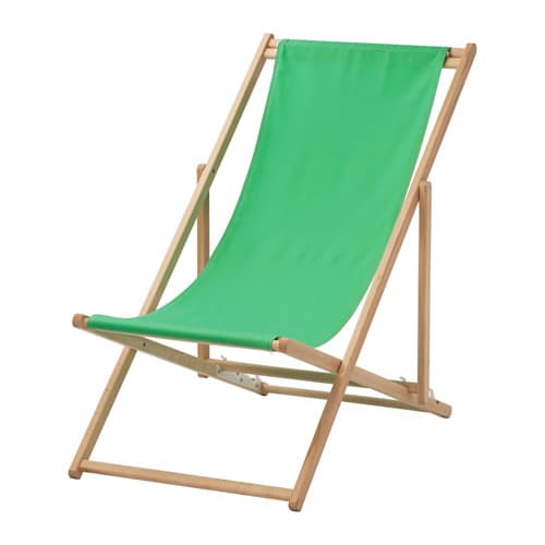 A foldable beach chair in wood with a green fabric seat.