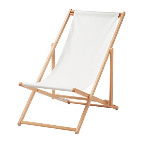 A foldable beach chair in wood with a white fabric seat.