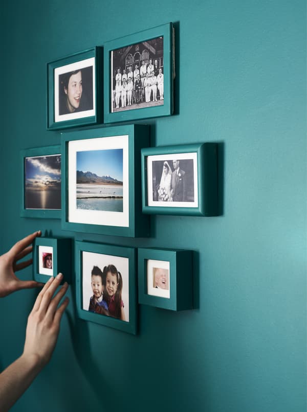 A gallery wall with painted photo frames.