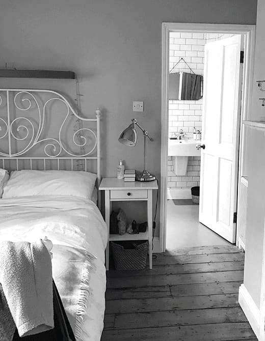 A GIF of a bedroom before and after a makeover where it goes from a grey colour palette to bright greens and yellows.