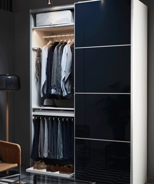 A GIF of a man’s closet with high-gloss, black-blue IKEA HOKKSUND doors, opening and closing.