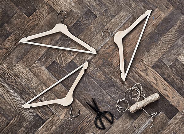 A GIF of how to create a unique jewellery hanger display using three IKEA BUMERANG hangers in natural solid hardwood.