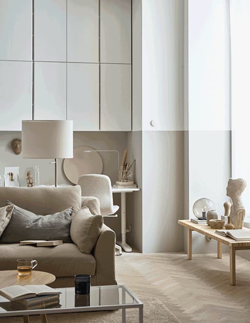 A GIF of the sun setting and lights coming on in a large living room.