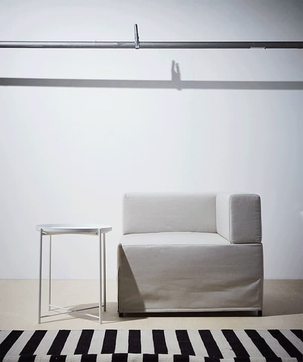 A GIF showing a table and chair being surrounded by yellow, black and striped home furnishing accessories.