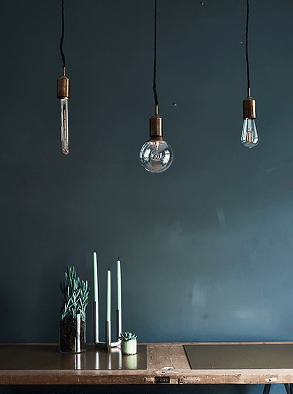 A gif showing bulbs hung over a dining table.