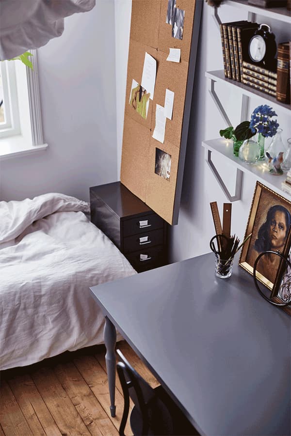 A GIF shows a bulletin board being lowered to create extra workspace together with the desk.