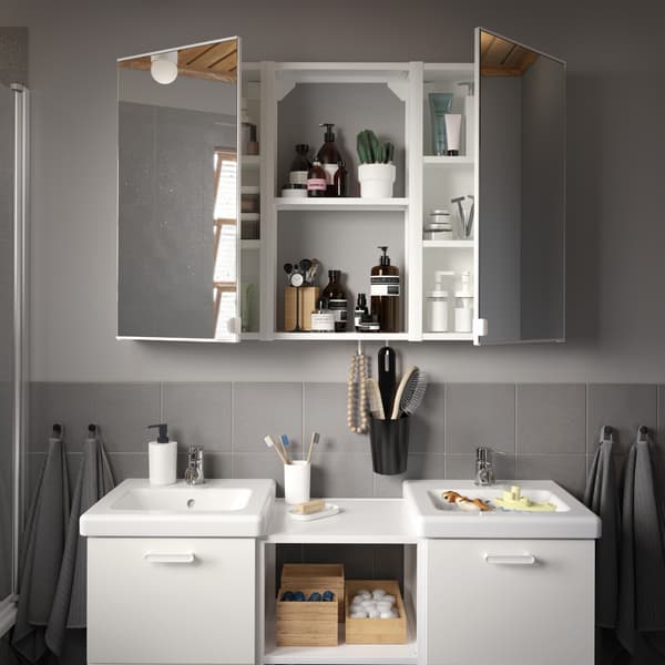 A grey/grey-tiled bathroom with a wash-stand/wash-basin in white, a wall cabinet with two mirror doors and four grey towels.