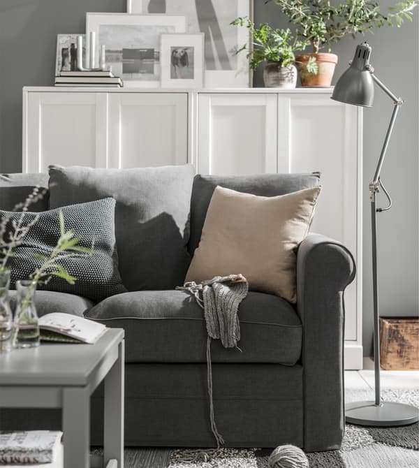 A grey sofa in a white and grey interior.