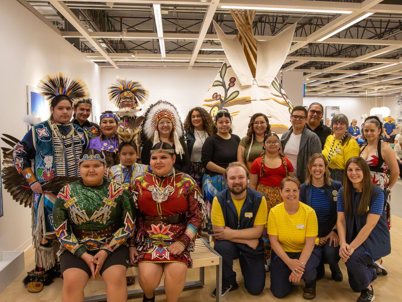 A group of people all pose together for a picture in an IKEA store.