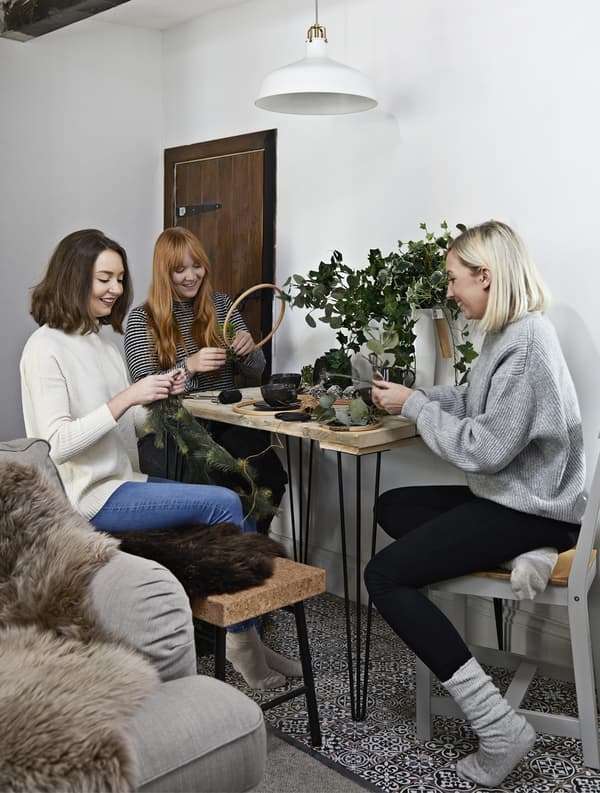 A group of women sitting around a table crafting.