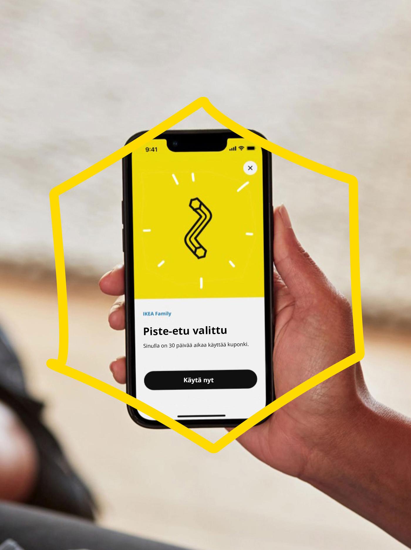 A hand is holding a phone with a drawing of an Allen key on a yellow background.