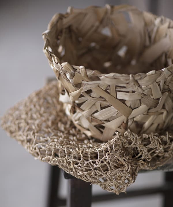 A handwoven banana fibre basket with an irregular weave from the IKEA ANNANSTANS collection.