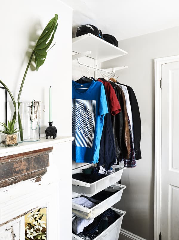A hanging rail and drawers in an alcove.