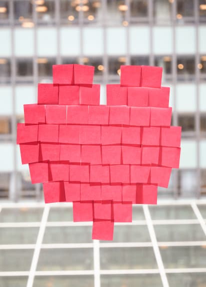 A heart created by pink sticky notes.