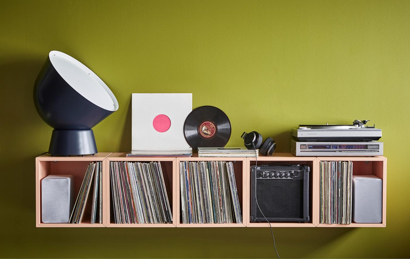 A home DJ-station uses EKET cabinets in light orange for record storage.
