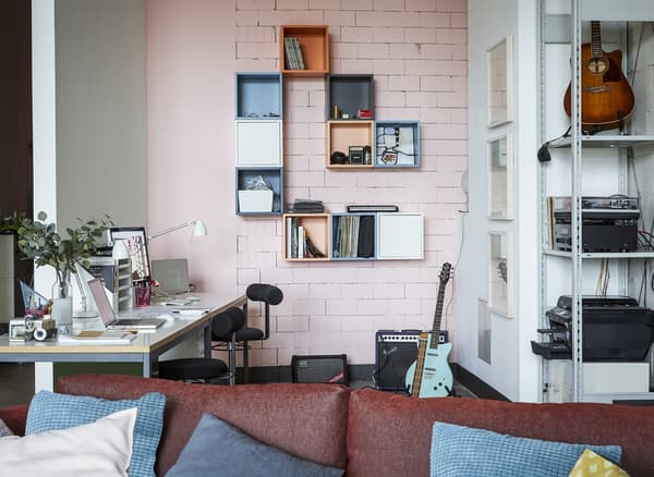 A home office with pink wall.