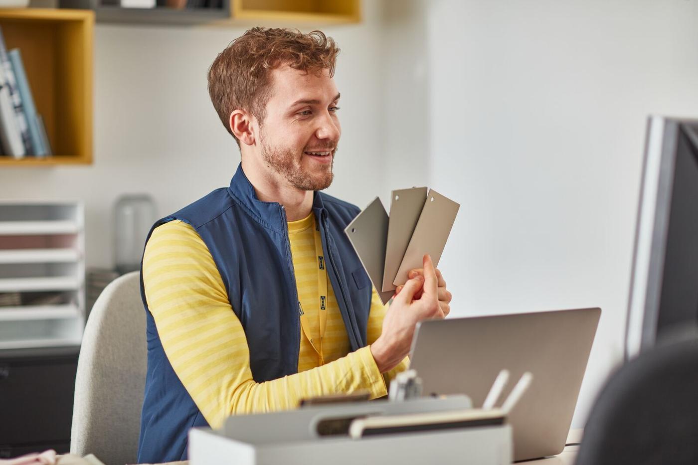 A IKEA employee behind a laptop
