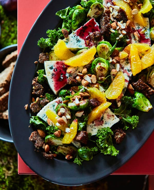  A kale and Brussels sprouts salad is topped with orange segments, rye bread crumbs, blue cheese and dried pears.