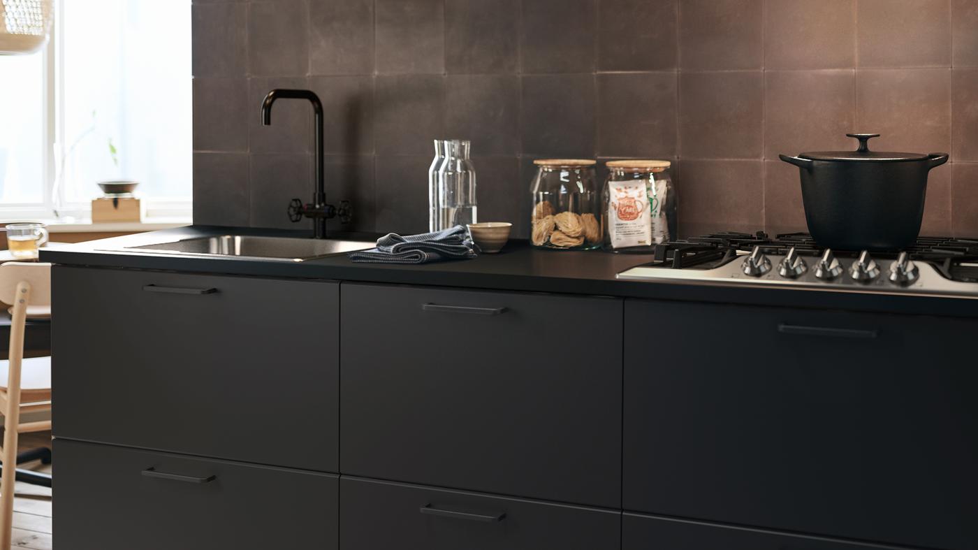 A kitchen area with SEKTION cabinets and an EKBACKEN counter top.