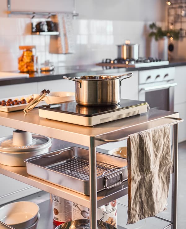 A kitchen island is set up for a group of people to make chocolate truffles.