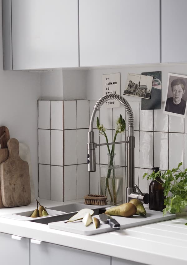 A kitchen sink and mixer tap with handspray. 
