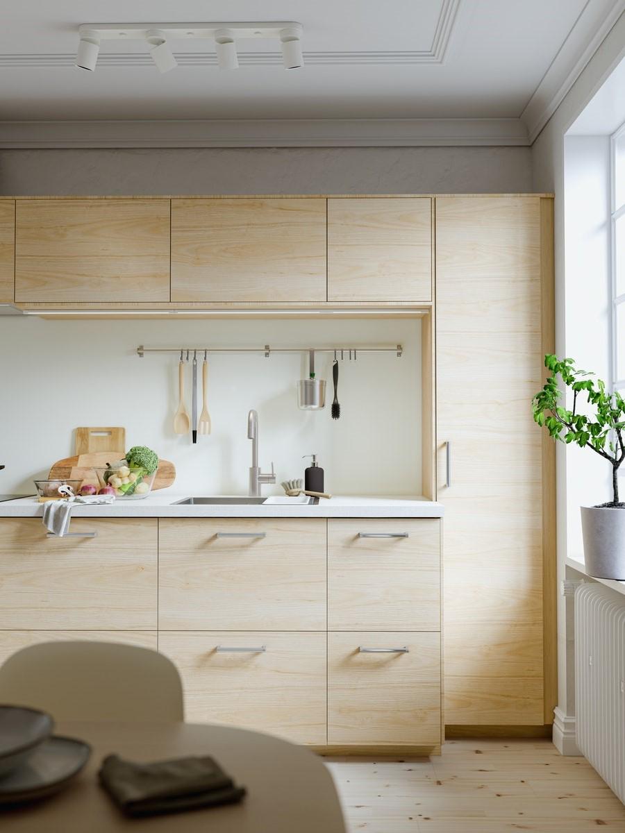A kitchen with light teal wood.