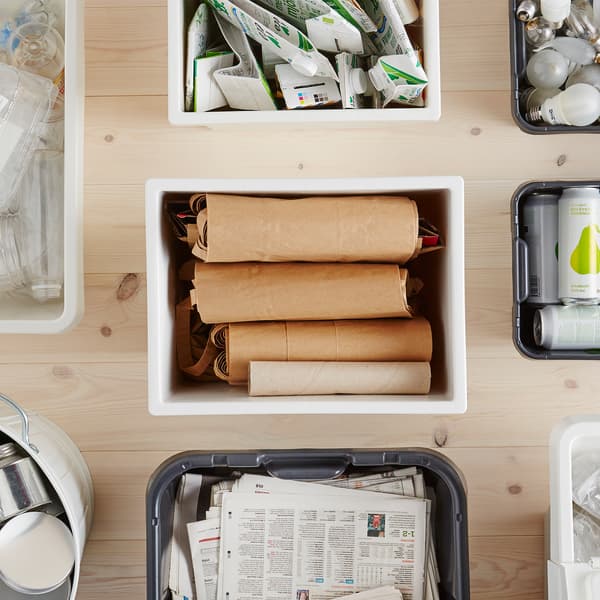 A KLÄMTARE plastic container surrounded by other storage boxes, filled with recyclables.