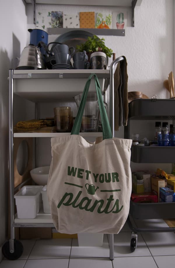 A large cotton bag hanging from some shelving.