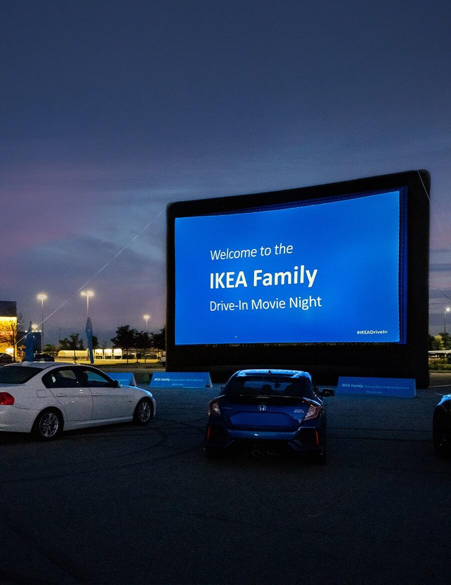 A large drive-in movie screen at sunset.