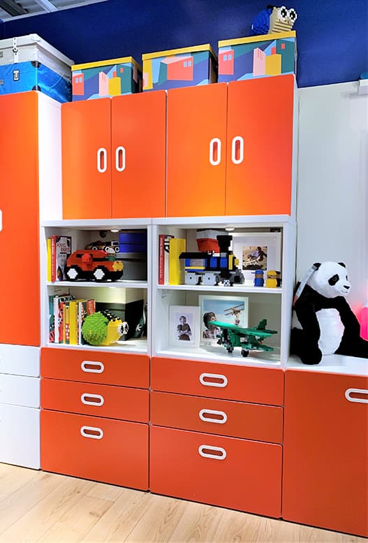 A large orange storage system inside of a kids room.