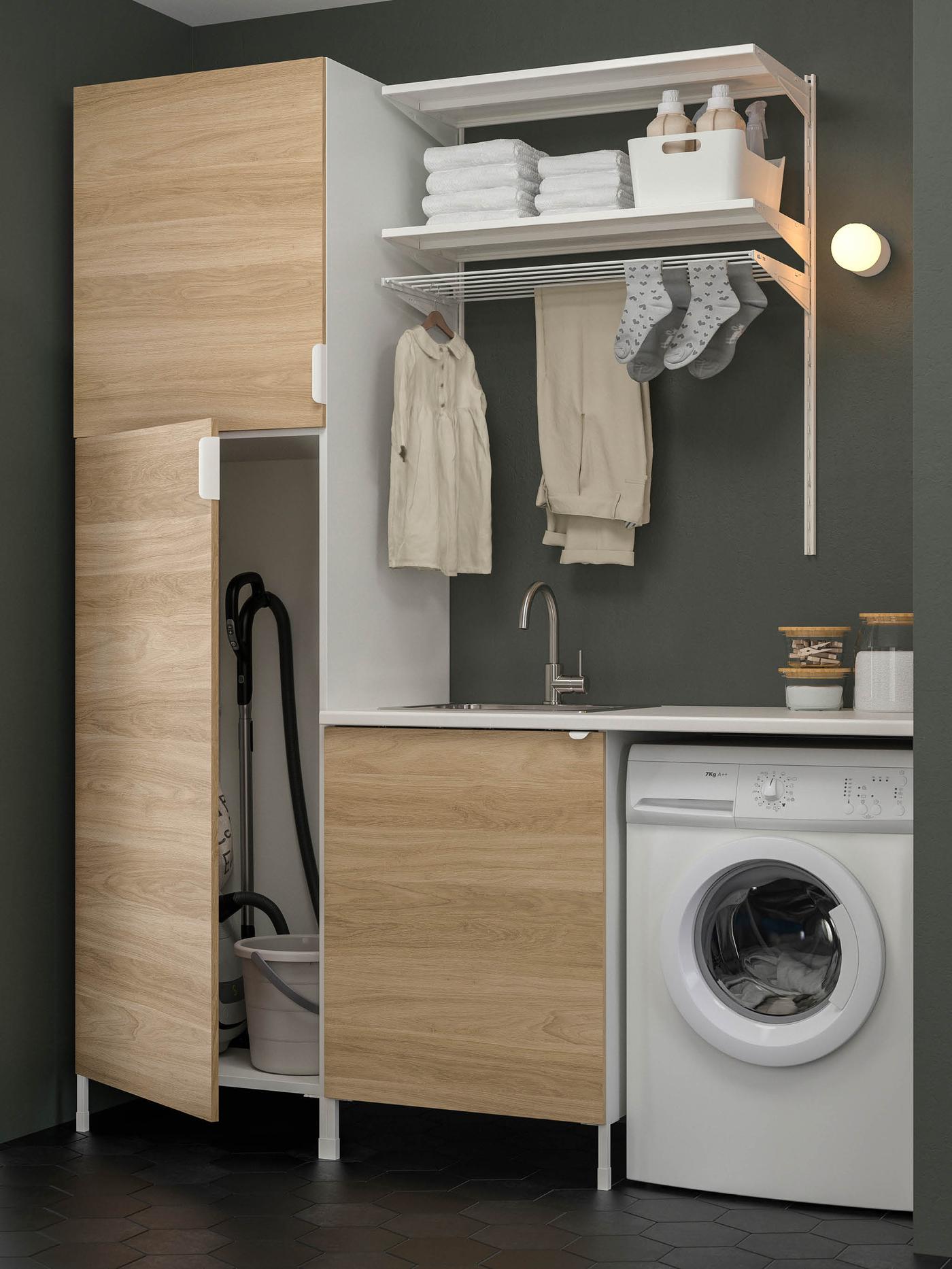 A laundry with washing machine, and plenty of storage.