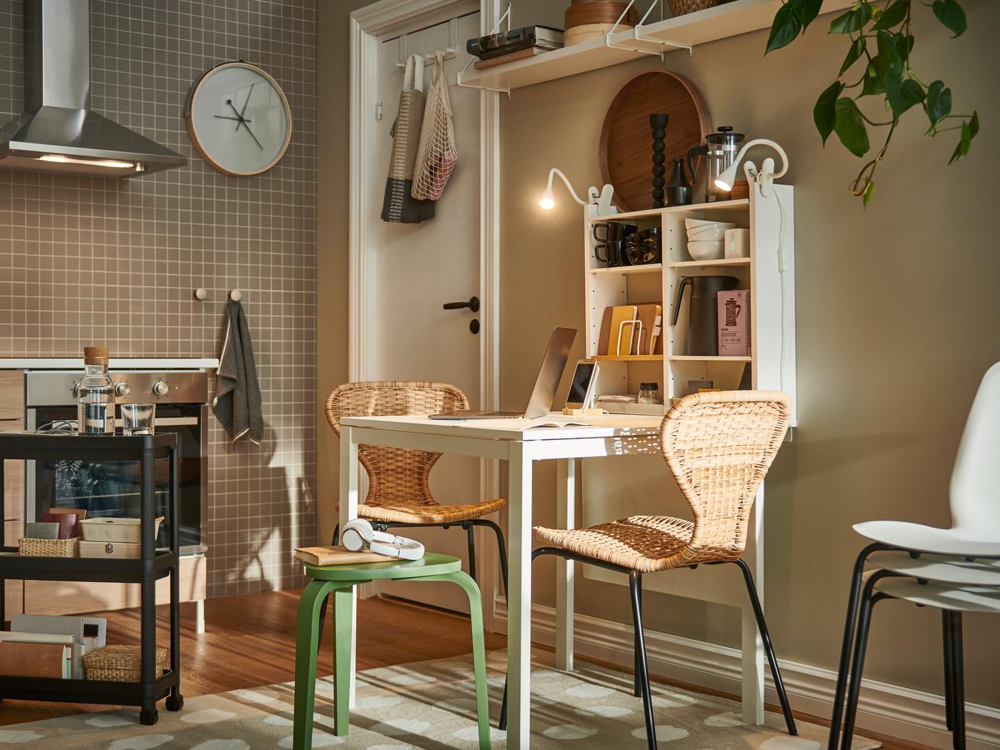 A light kitchen with ÄLVSTA rattan-seat-and-black-frame chairs and other seating at a white MELLTORP table.
