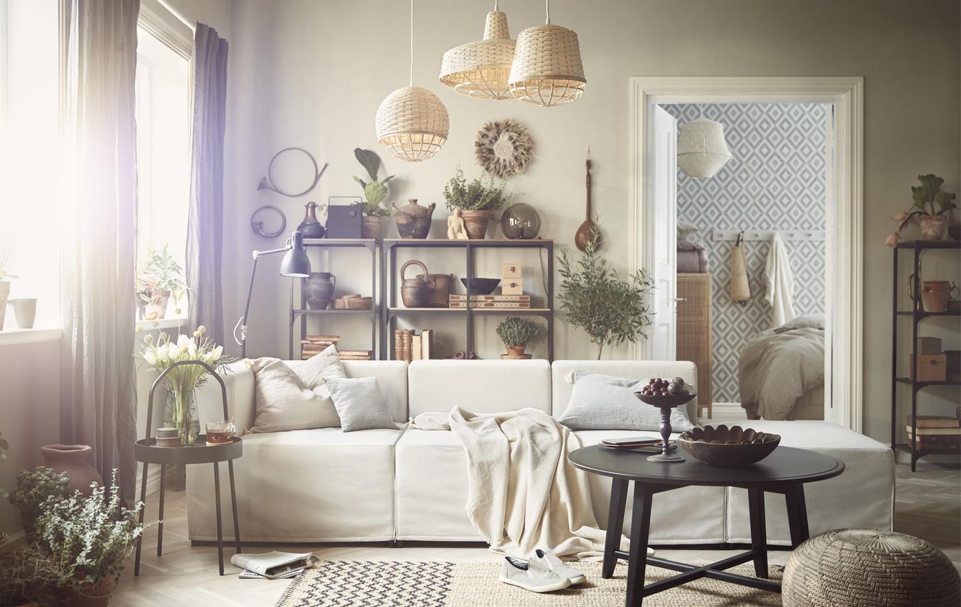 A living room decorated with wicker, wood and a beige sofa.