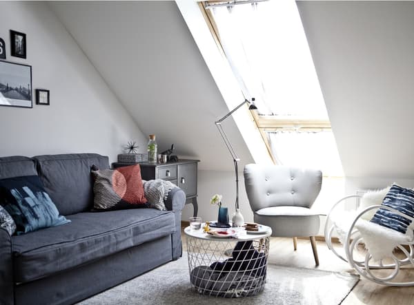 A living room with a grey sofa and two armchairs.