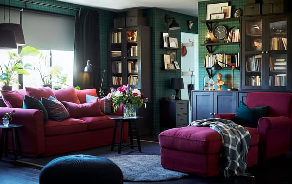 A living room with sofa and chaise longue upholstered in red fabric