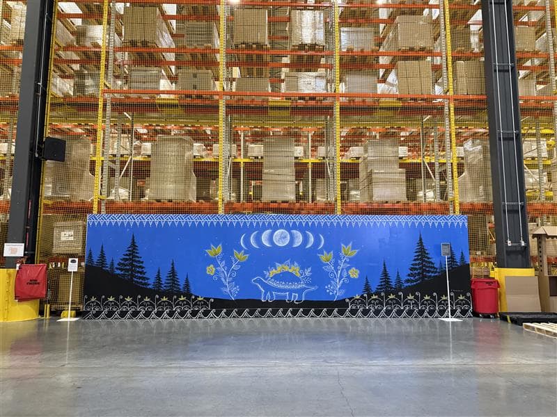 A long shot of a blue mural painted outside the Beaharnois Distribution Centre.