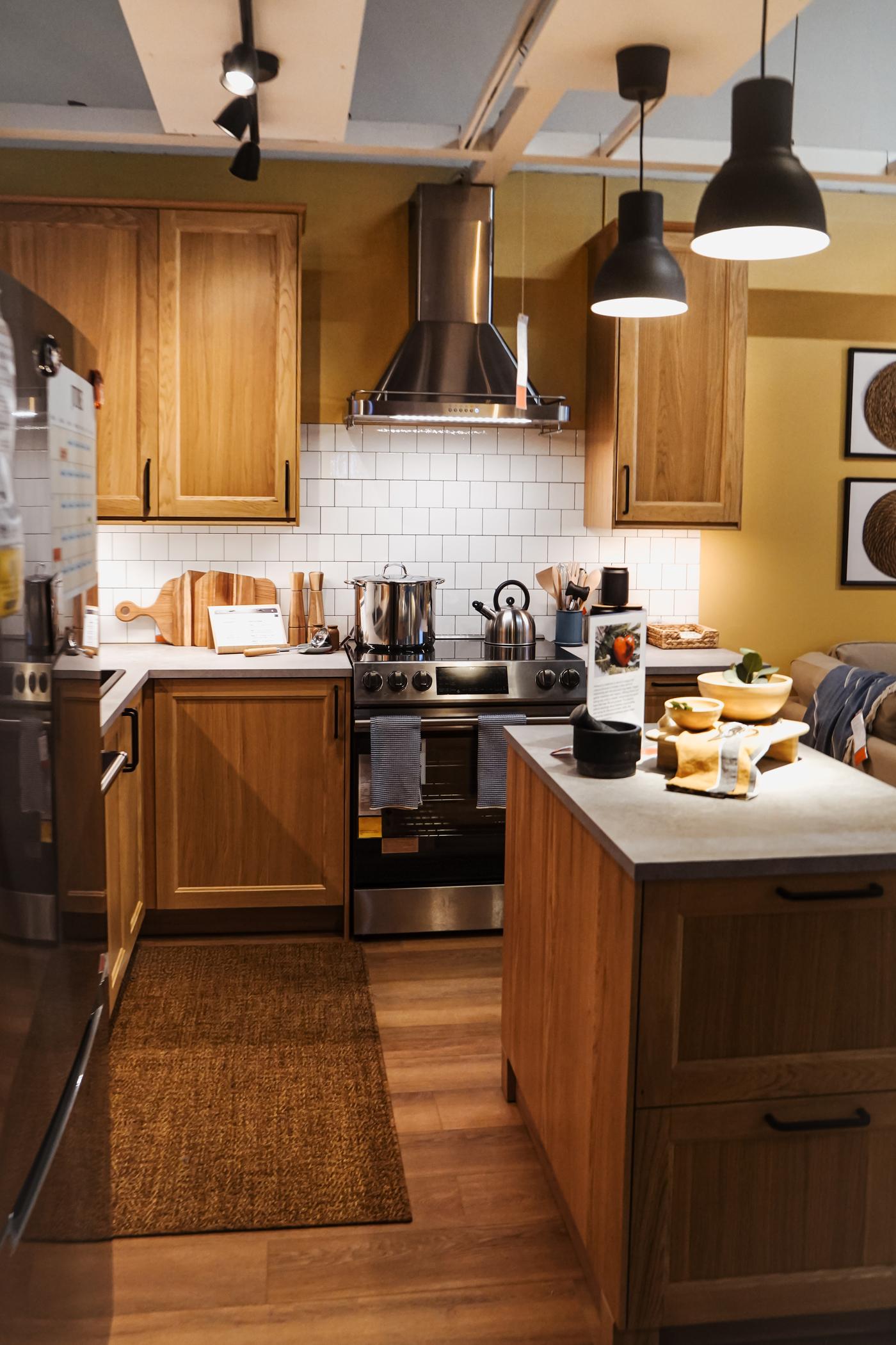 A long shot of a kitchen room setting.