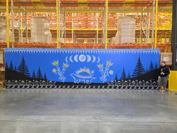 A long shot of a large wall mural outside of a distribution centre. 