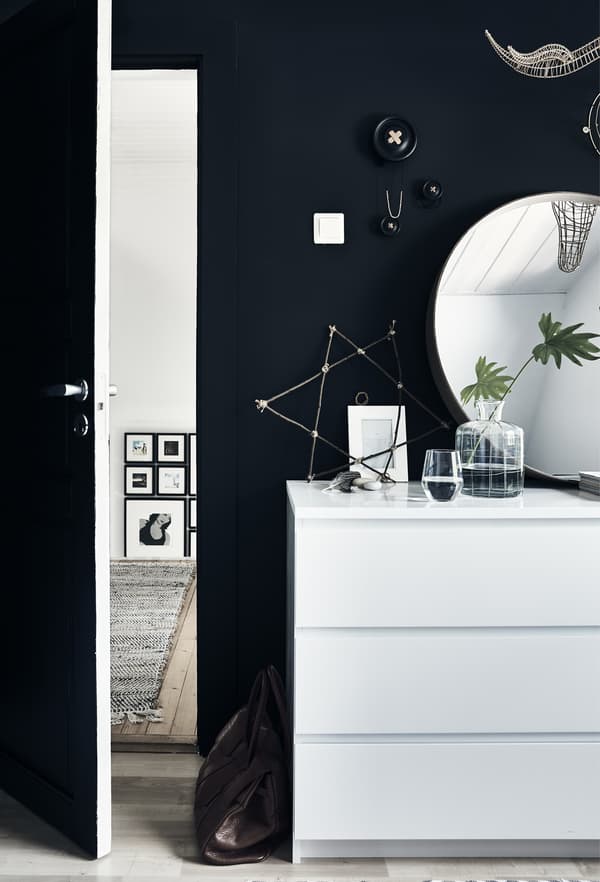 A MALM chest of drawers in a black bedroom.