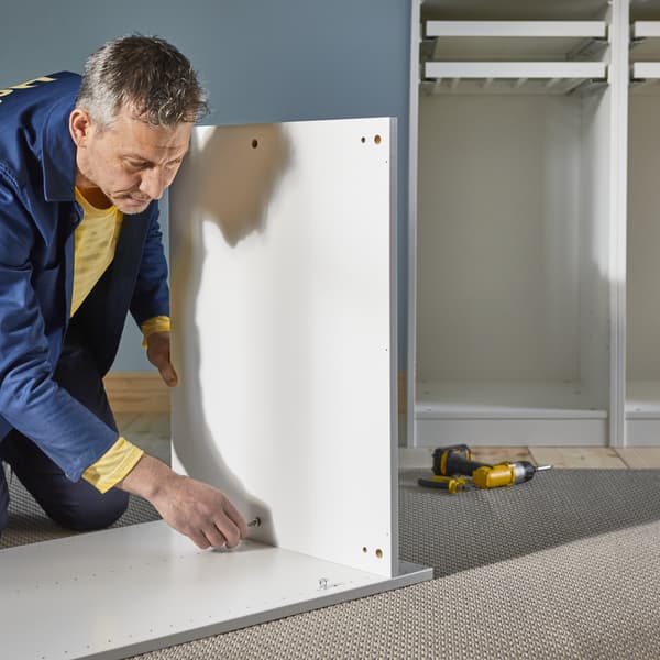 A man assembled a wardrobe
