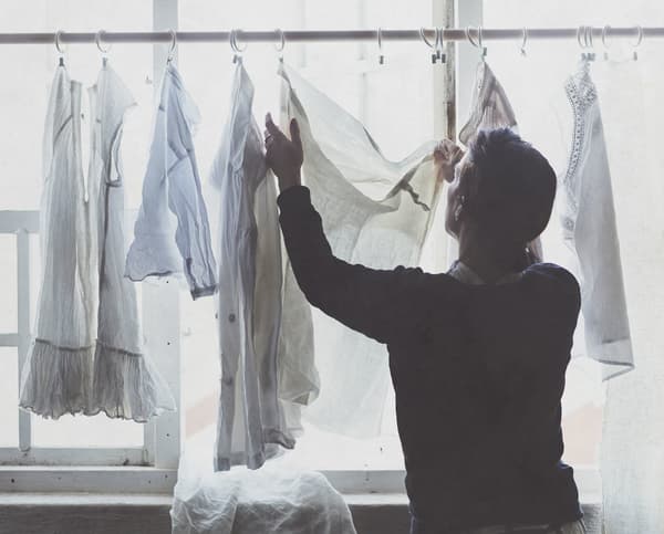 A man hanging up his clothers to dry.
